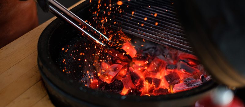 Chef preparing charcoals before grilling in a restaurant.